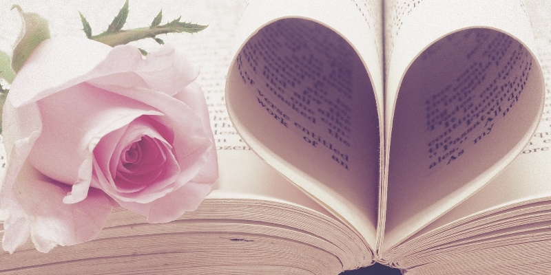 book with pages shaped into a heart and a pink rosebud