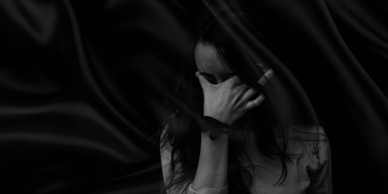 girl with her face in her hands - showing frustration/exhaustion/emotional annoyance